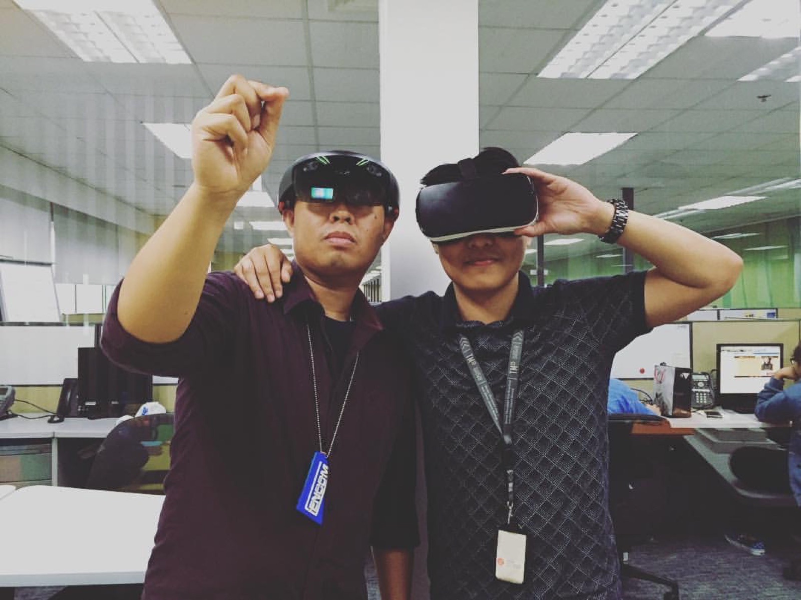 Two colleagues experimenting with virtual reality headsets